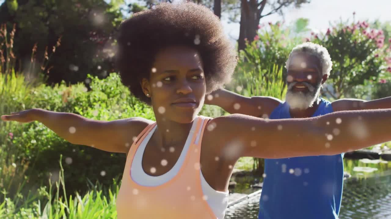 Animation of light spots over african american couple doing yoga, stretching, slow motion