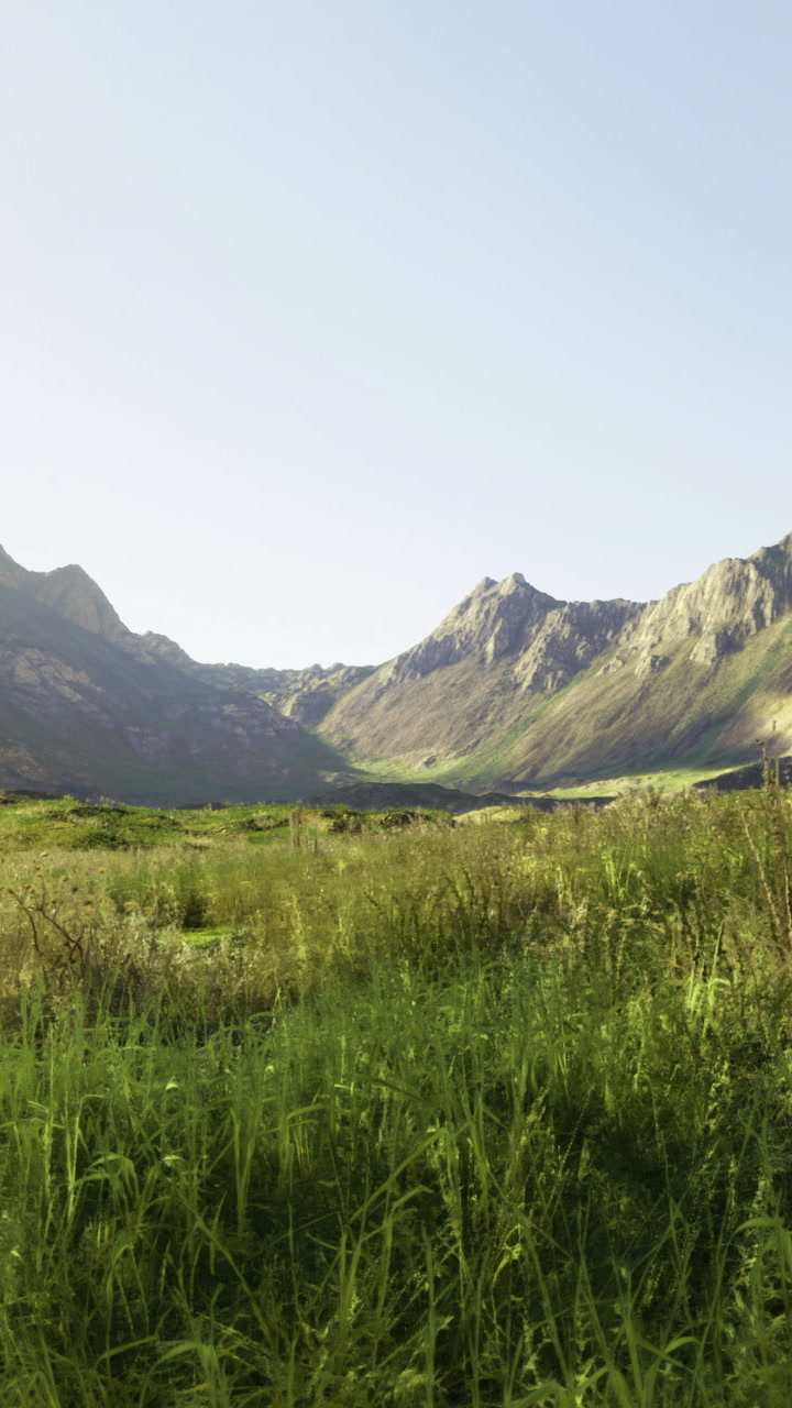 Mountains and green fields view during daylight near a valley in nature