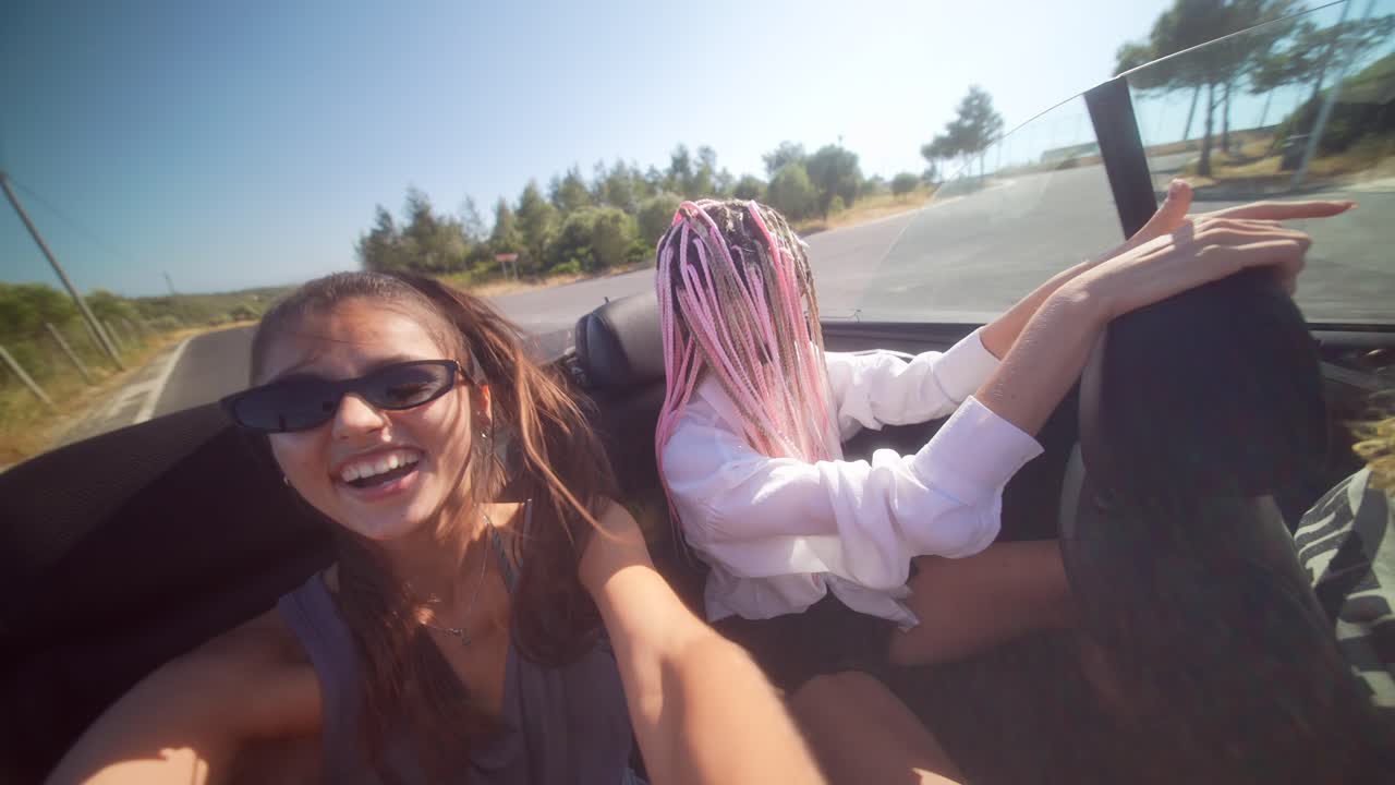 Friends Enjoying a Sunny Convertible Road Trip