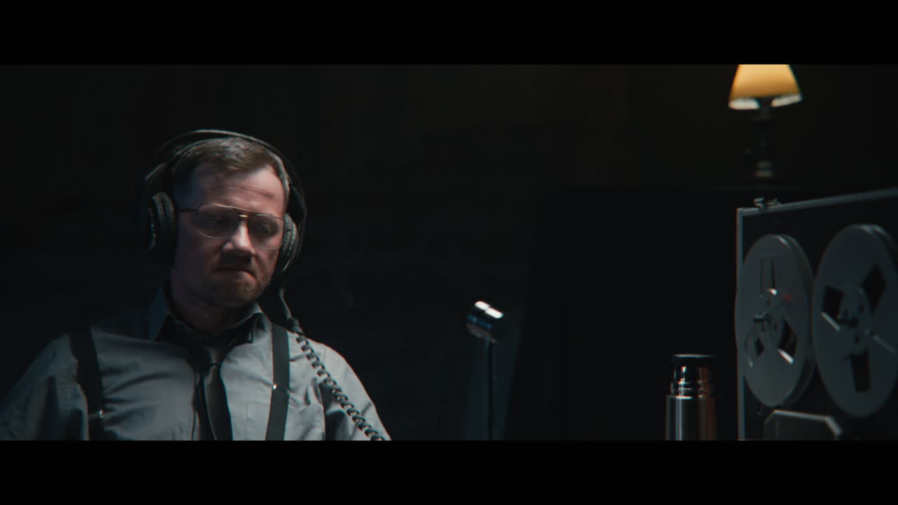 An intelligence officer listens to the wiretap recordings