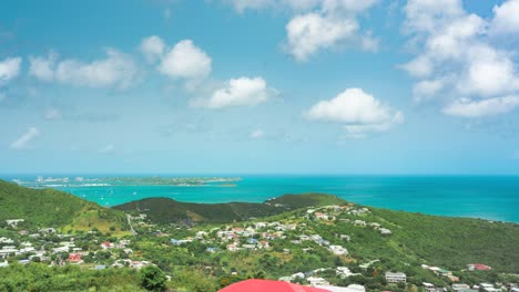 timelapse shot of saint martin island with white clouds passing over it.