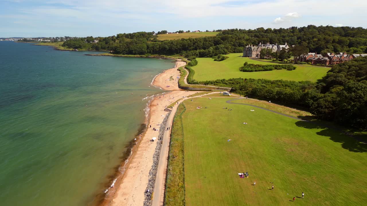 Centered aerial video of Helen's Bay beach in County Down, Northern Ireland, UK on a bright summer day. Filmed in 4K, 60FPS and with Rec709 color