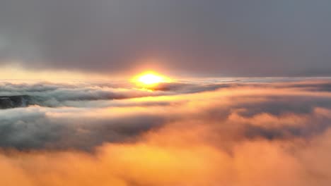 sunset video over the clouds, sun paints the sky orange at the perfect golden hour time