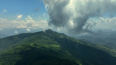 volando a través de nubes blancas y esponjosas por encima de los picos verdes de las montañas
