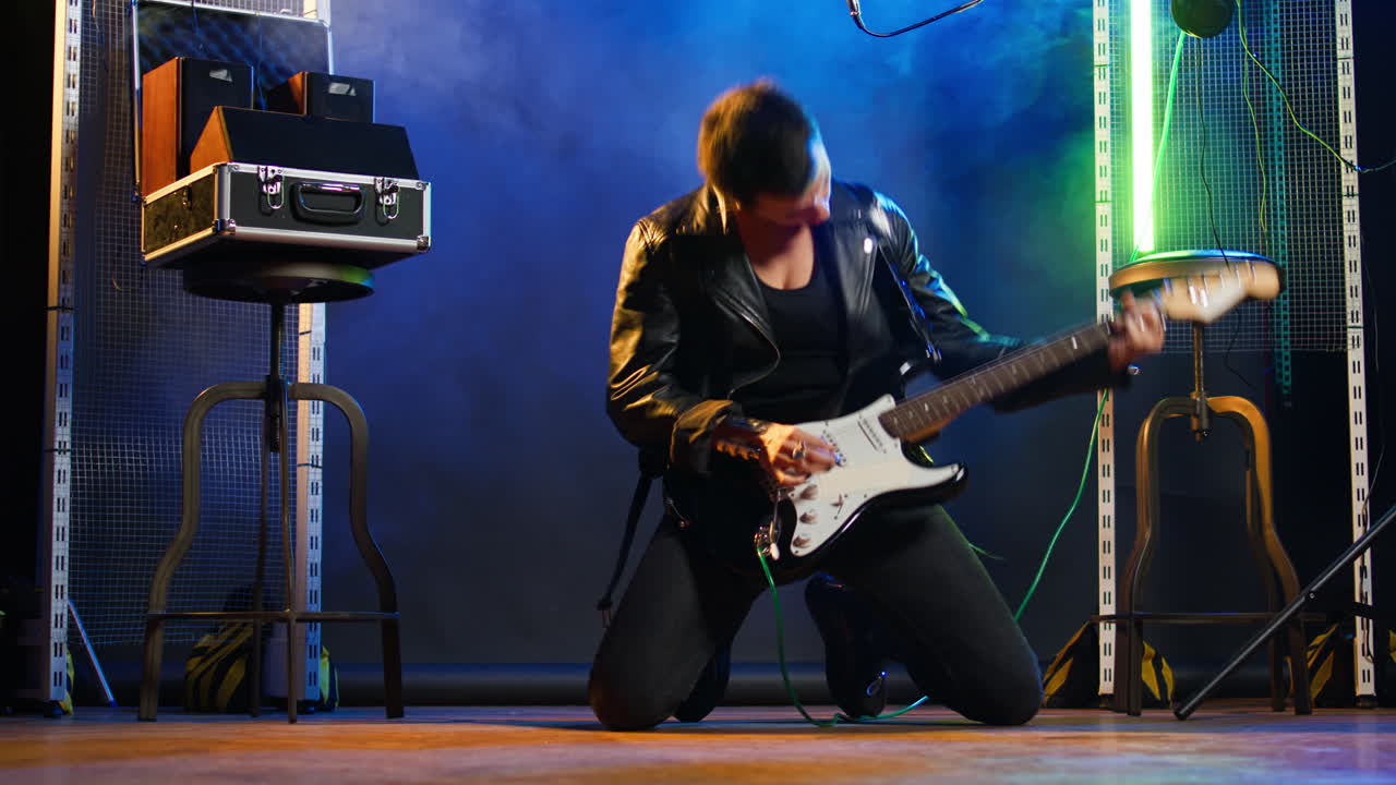 Woman singing and playing guitar on stage