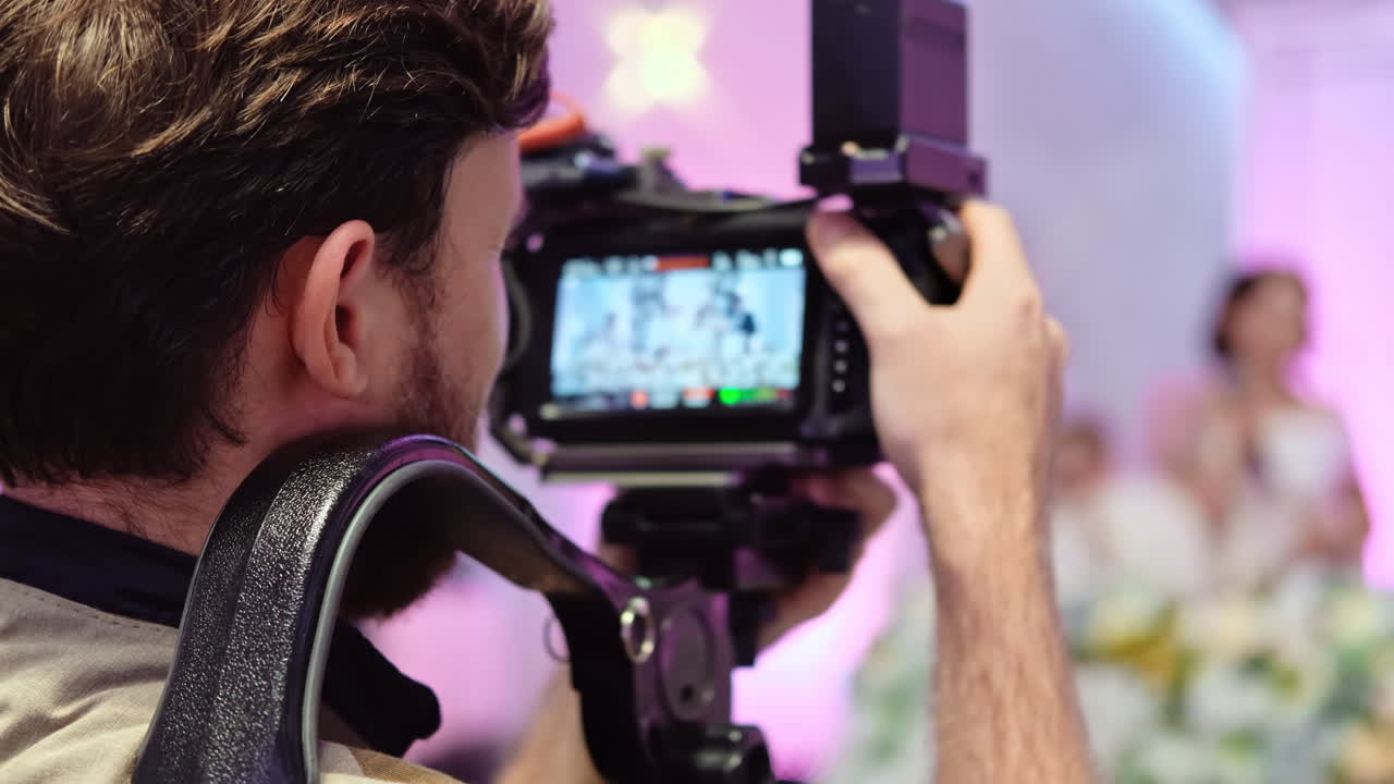 Working photographer on a wedding. Talking woman