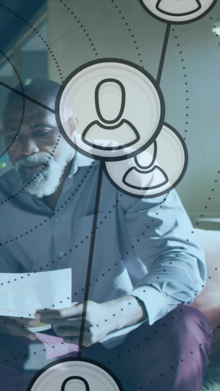 Vertical video: Man reading papers, glancing up starting tech nodes overlay moving over then aside