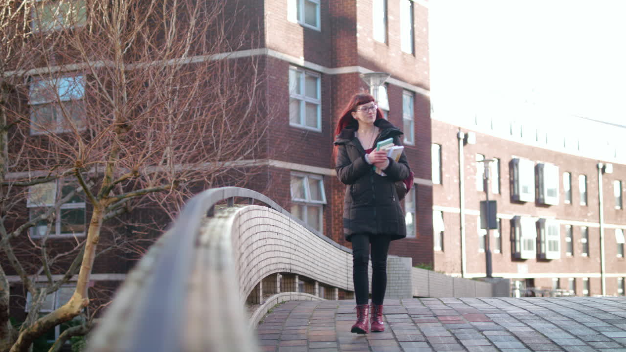 slow motion shot of hipster student carrying books to class