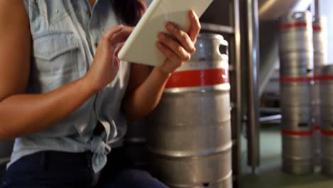 Female-brewer-using-digital-tablet-at-brewery-4k