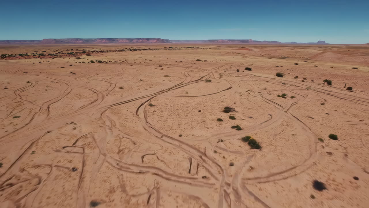 Aerial View of a Desert Landscape with Vehicle Tracks