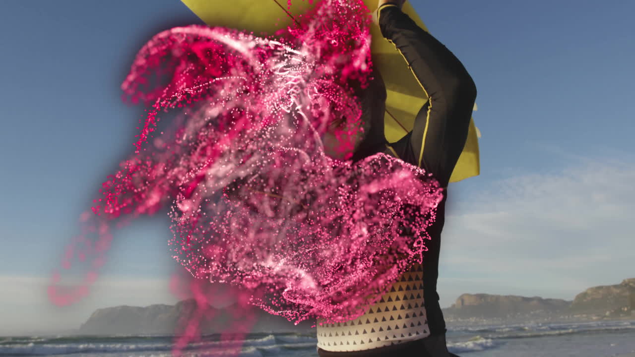 mature surfer holding yellow surfboard on beach, showing health chart with swirling pink particles