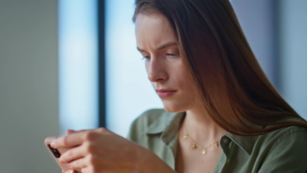 Closeup girl drinking coffee at domestic atmosphere. Serious woman worried