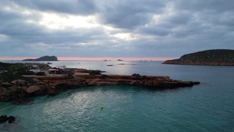 best aerial top view flight yoga girl position tree sunset cliff beach island ibiza spain very close passing flight drone