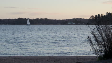 lonely boat sailing in baltic sea at dusk in slow motion