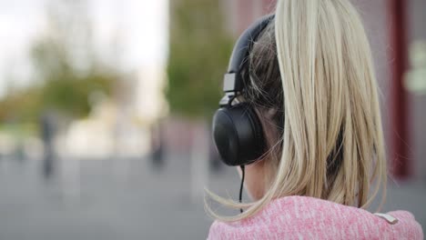 Handheld-view-of-jogging-woman-listening-to-music