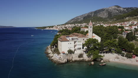 coastal croatian town with church and beach
