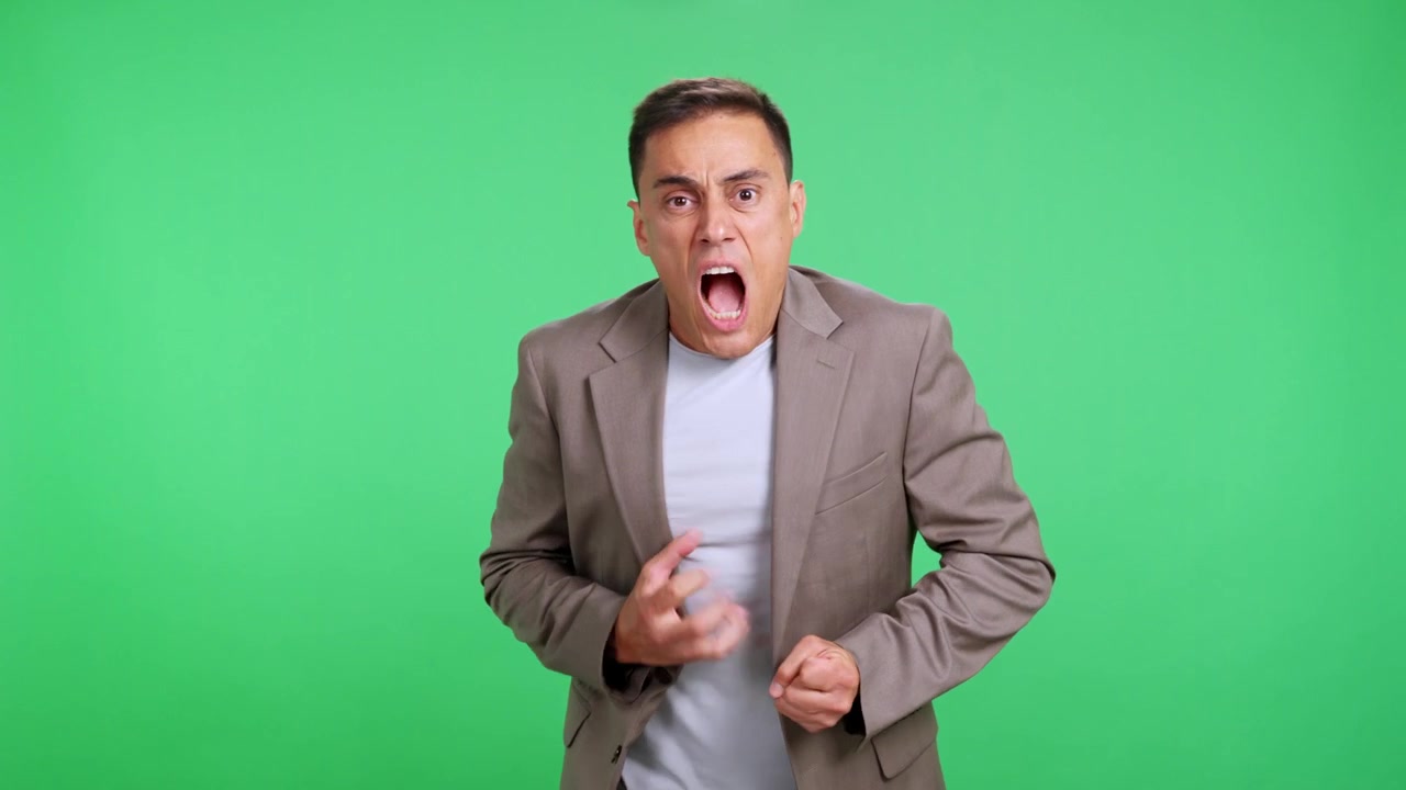 Fearful man expressing horror on green screen