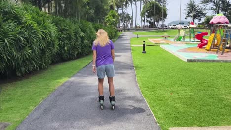 woman rollerblading in a tropical park