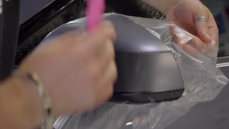 applying car wrapping foil on an exterior rear