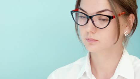 Young Woman with Glasses Looking Down