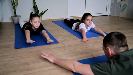 man and kids exercising in class