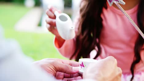 Father-and-daughter-having-toy-tea-party