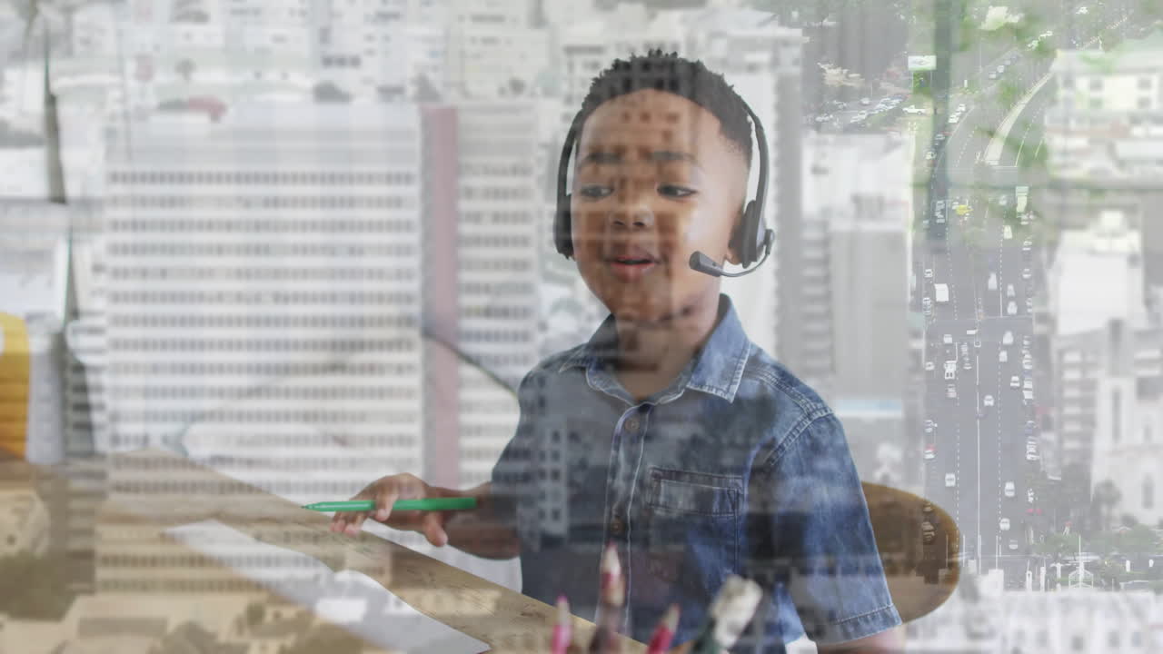 Wearing headset, child drawing animation at school desk with cityscape view