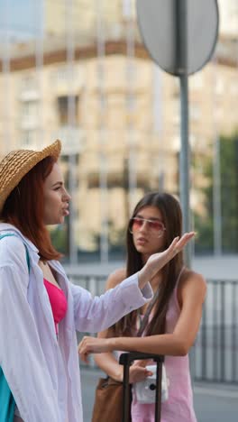 two women talking outdoors