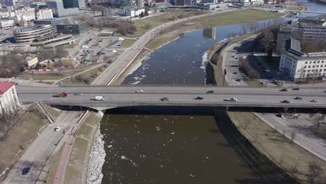 AERIAL:-Automobiles-drives-over-bridge-on-a-Chilly-Cold-Spring-Day