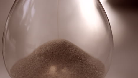 Hourglass-sand-falling-in-slow-motion-close-up