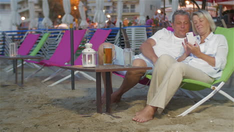 Couple-with-Smartphone-on-the-Sun-Lounger