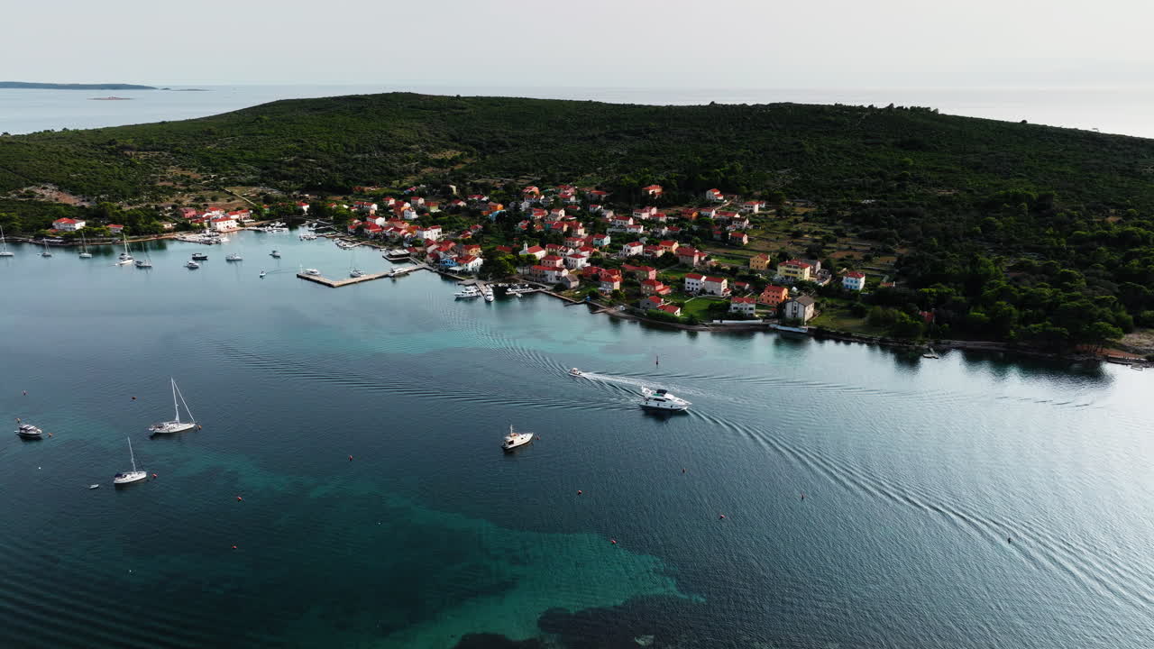 Boats pass by each other entering and exiting port harbor of Ilovik island Croatia