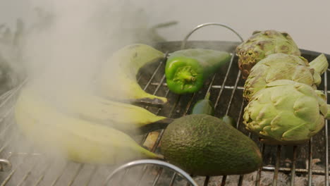 grilled bananas, artichokes, avocado and peppers on barbecue