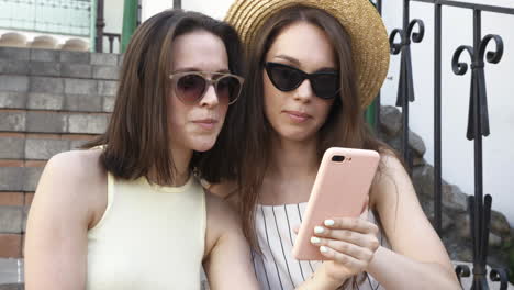 two women looking at a phone