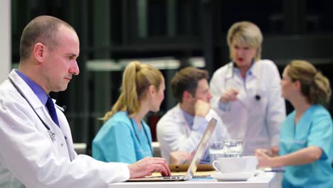 Doctor-using-laptop-in-conference-room