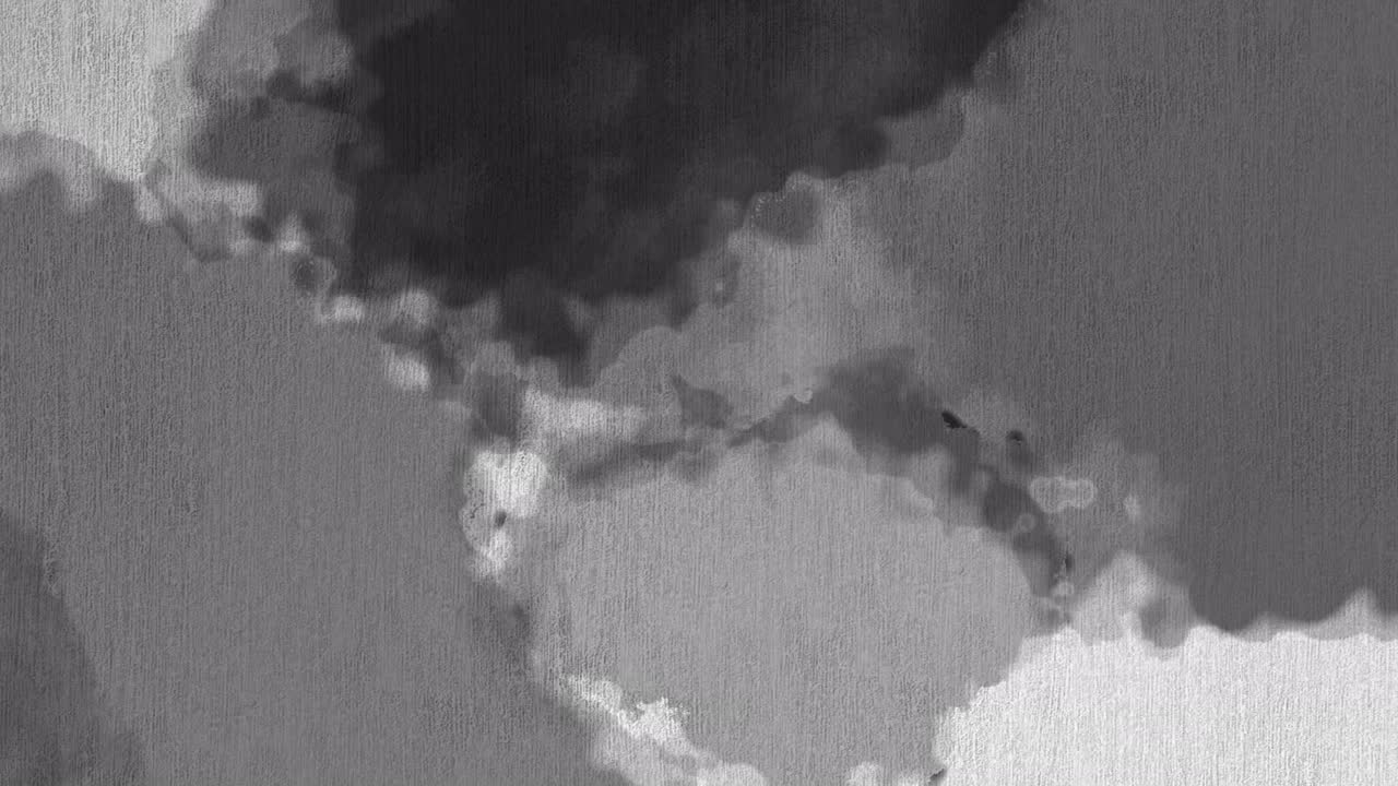 animación de manchas grises y negras que aparecen sobre un fondo gris