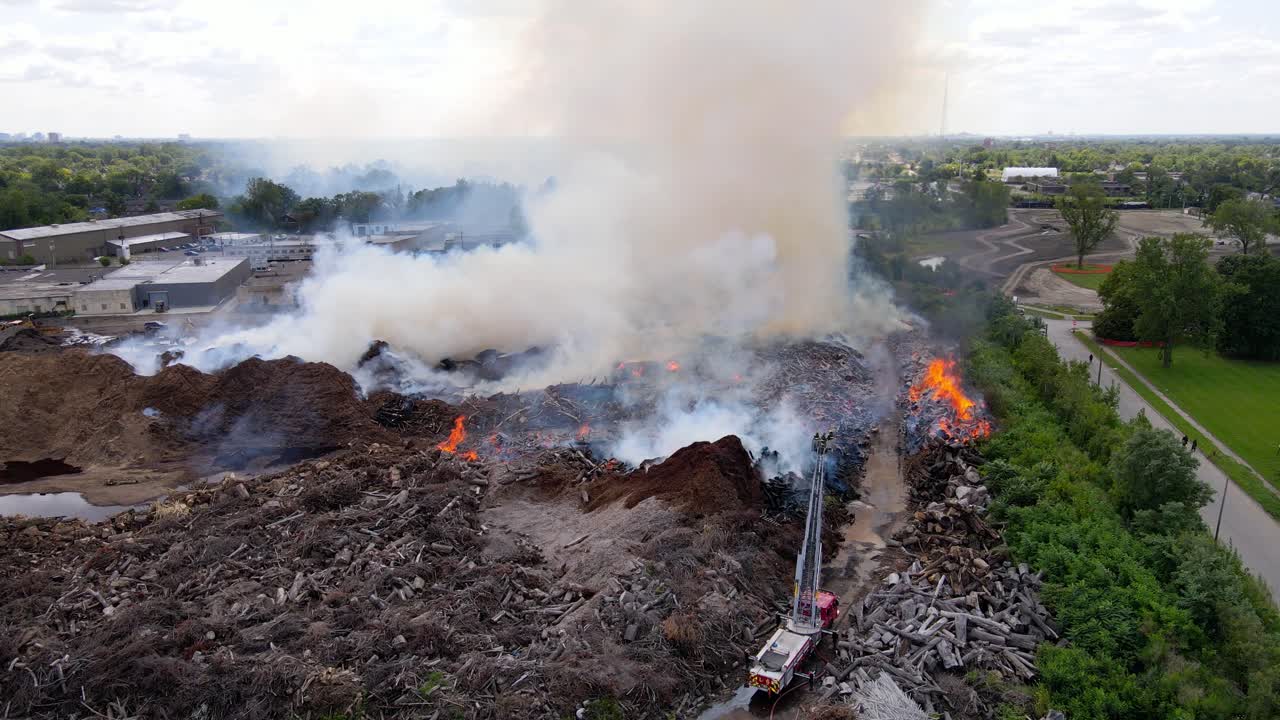 Massive flames and smoke from mulch company in USA, aerial view