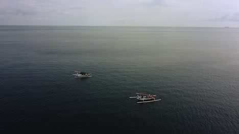 aerial pairs of fisherman boat isolated in blu clear clean calm flat ocean