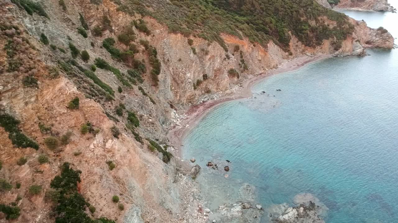 Sardaignan shore and sea, diving view from a drone by sunset