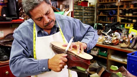 cobbler working on shoe sole