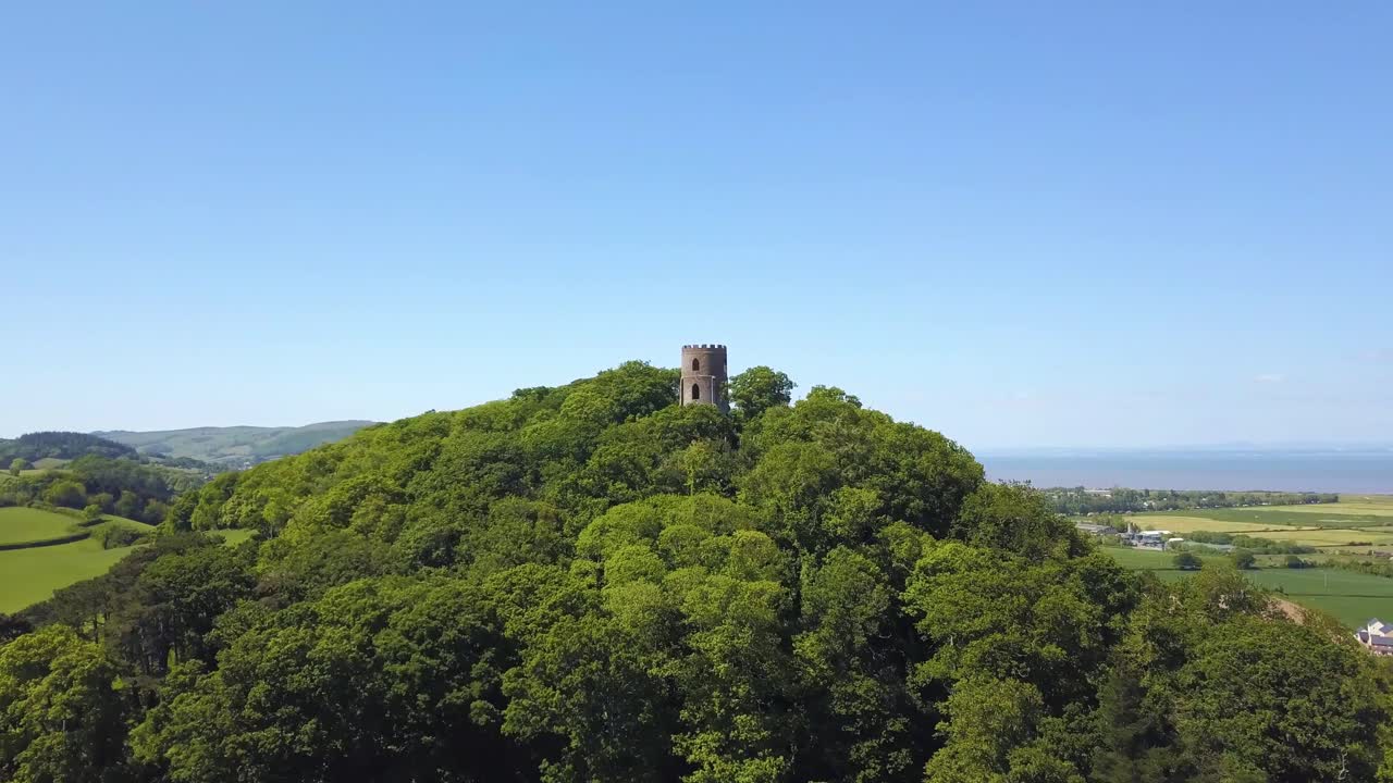 Aerial view of the Dunster Conygar tower and surrounding areas full of trees near Dunster castle, Somerset, England.