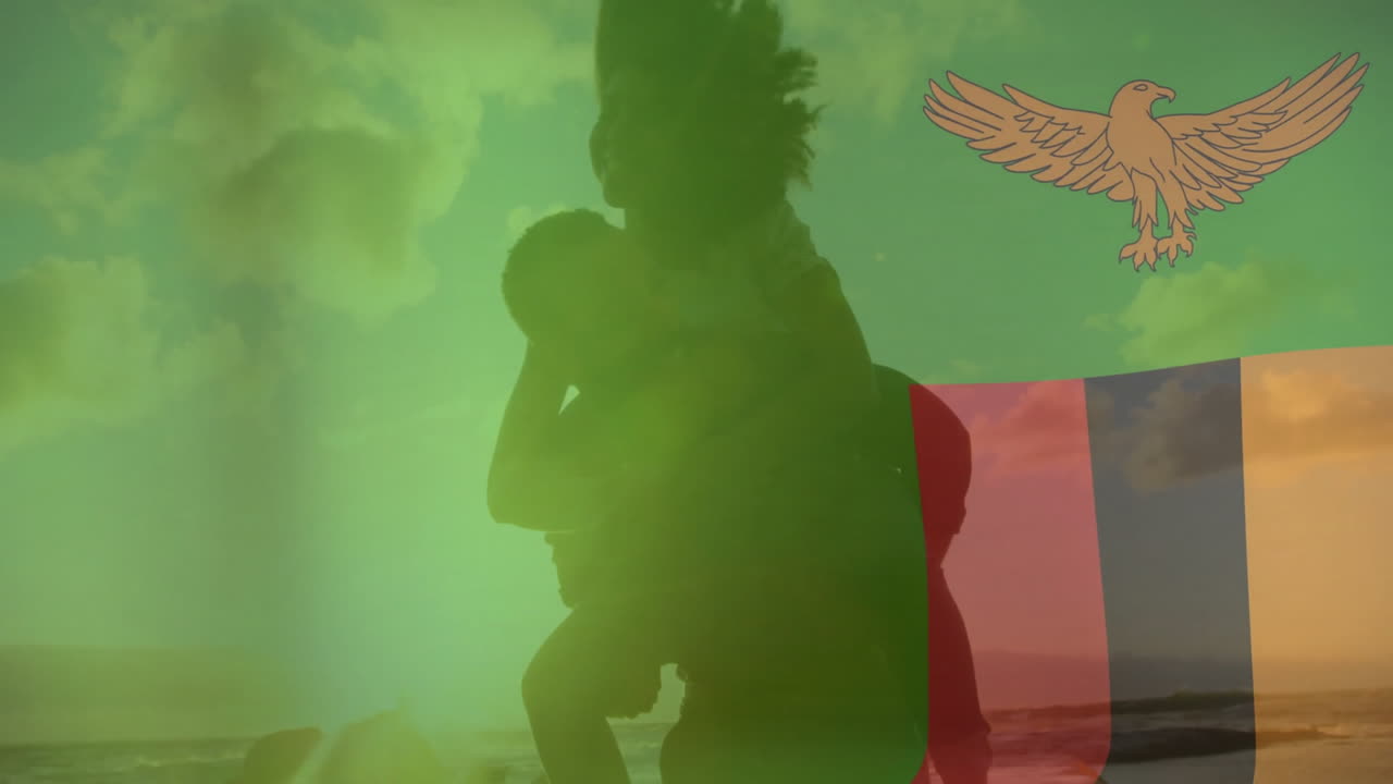 Holding child, person silhouetted against Zambian flag with eagle emblem animation