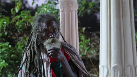 indian old saint with dramatic presence with tresses hair and beard at evenin