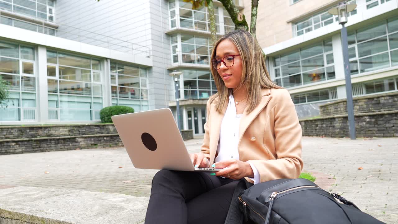 Businesswoman working on a laptop outdoors