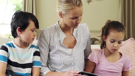 Family-watching-photo-album-together-in-living-room