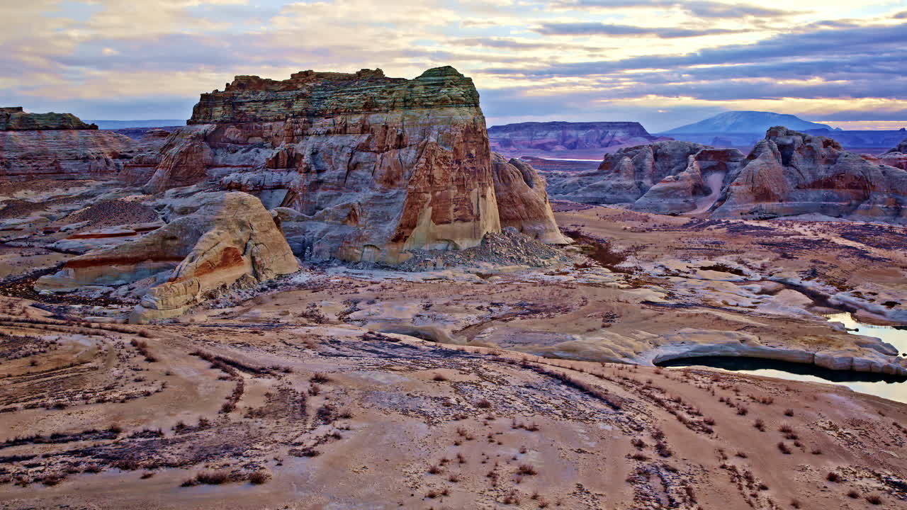 Aerial view of a drone flying toward distinctive rock formations near Lake Powell in Page, Arizona.
