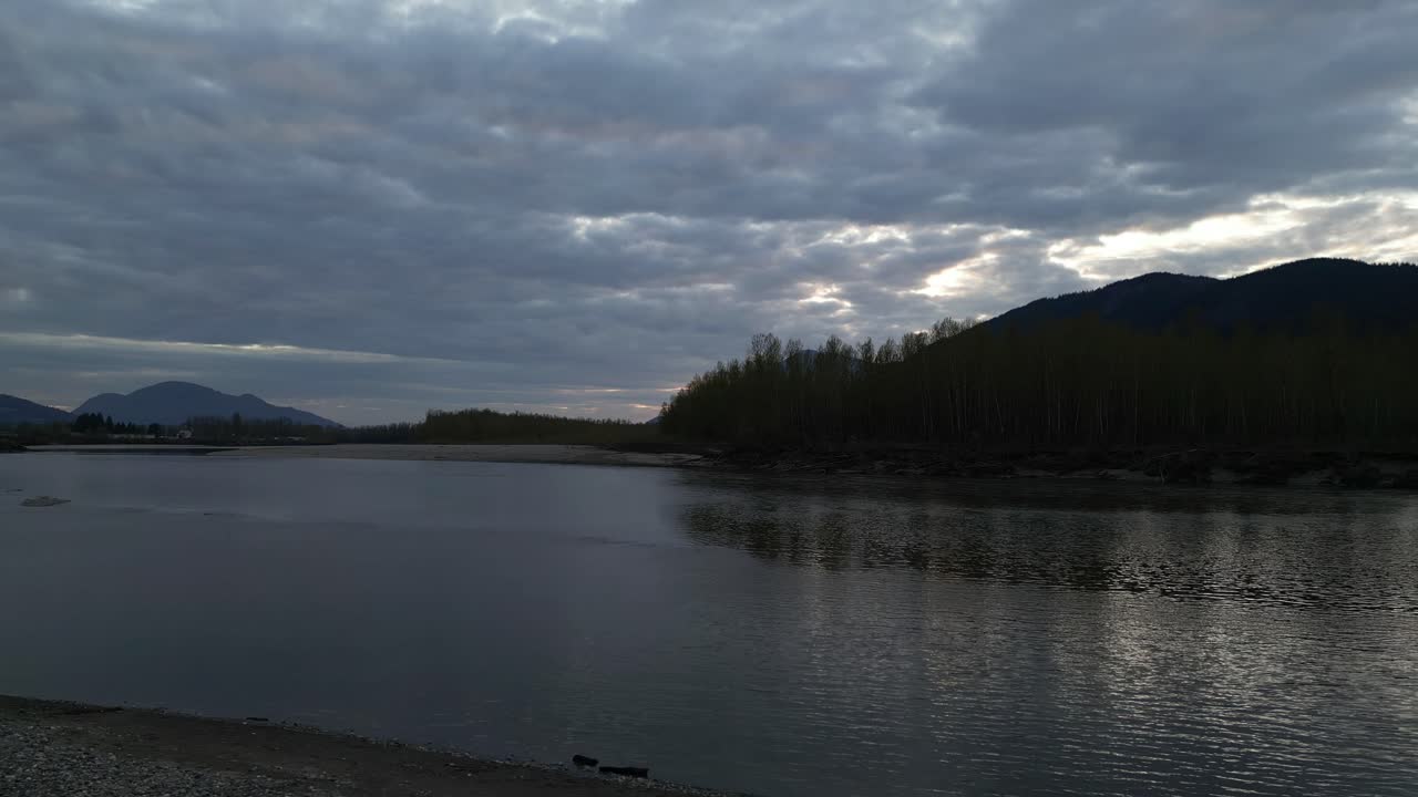 River, Shore with Trees and Mountains at Sunset. Spring Season. Fraser Valley, British Columbia, Canada.