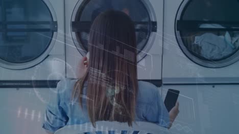 animación del procesamiento de datos financieros sobre una mujer usando un teléfono inteligente en la lavandería.