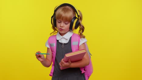 Schoolgirl-listening-music-via-headphones,-dancing-disco-fooling-around-having-fun-gesticulating