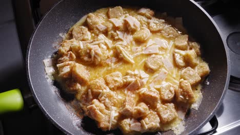 close up of toast omelette mixture in a frying pan seasoned with paprika powder